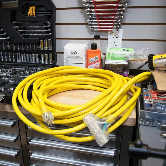 DuroMax 50-Foot 10 Gauge Triple Tap Extension Power Cord Lying On A Tool Chest