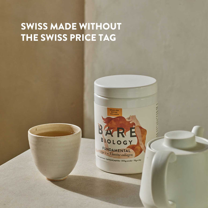 Bare Biology Fundamental Collagen supplement container with a cup of tea on a neutral background