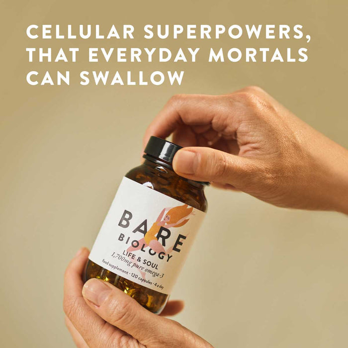 A person holds a bottle of Bare Biology Life & Soul Omega-3 Fish Oil Mini Capsules, rich in DHA and EPA, against a neutral background with the text “Cellular superpowers, that everyday mortals can swallow” above.