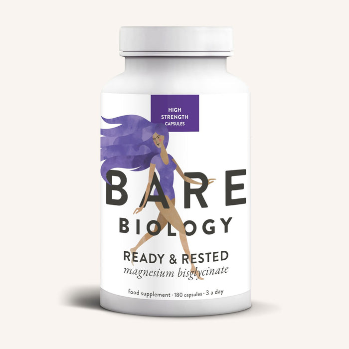 A white bottle of Bare Biology Magnesium Bisglycinate Capsules, with a purple-haired woman running on the label, offers easy absorption and nervous system support.