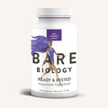 A white bottle of Bare Biology Magnesium Bisglycinate Capsules, with a purple-haired woman running on the label, offers easy absorption and nervous system support.