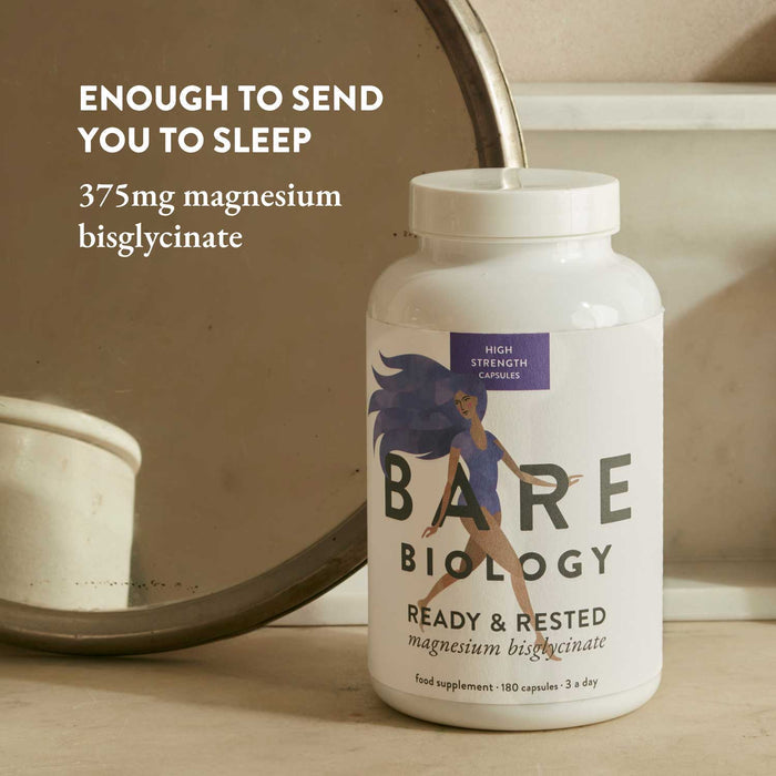 Colourfully illustrated Bare Biology supplement bottle with text about magnesium bisglycinate on a neutral background.