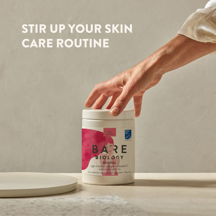 Person reaching for a Bare Biology Marine Collagen with Vitamin C product container on a neutral background