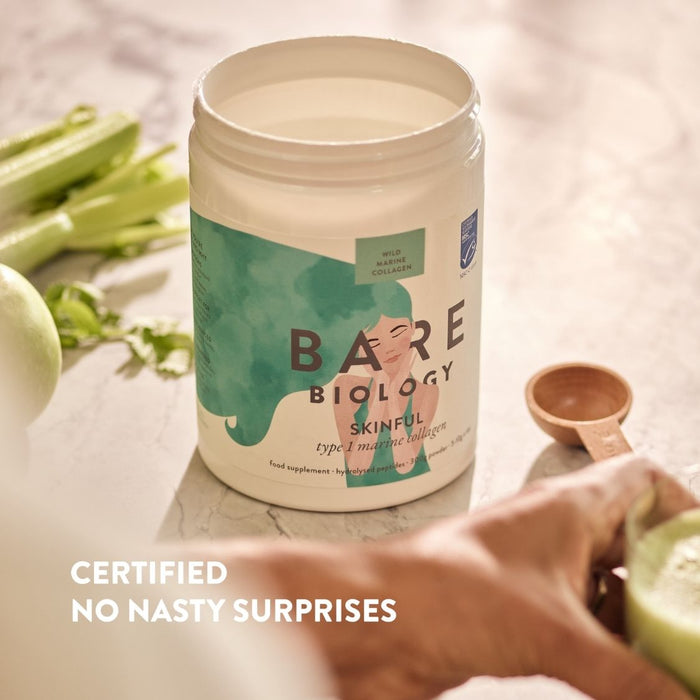 Bare Biology supplement container on a table with vegetables in the background